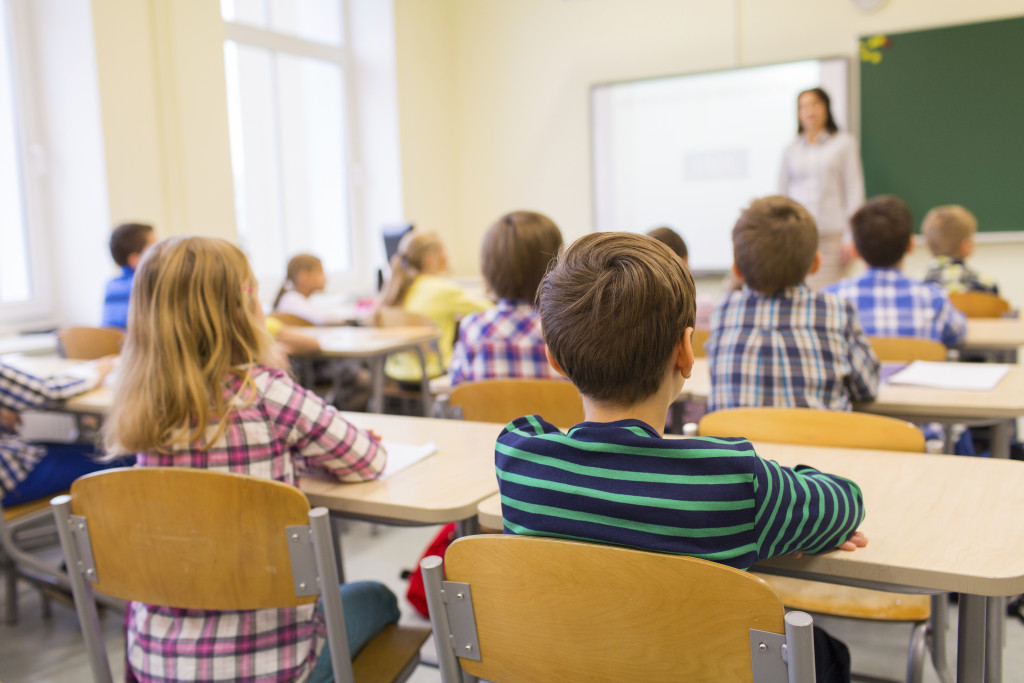 group of school kids and teacher in classroom | Whitehouse Communications