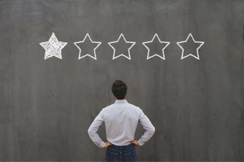 Man looking at chalkboard with one star.