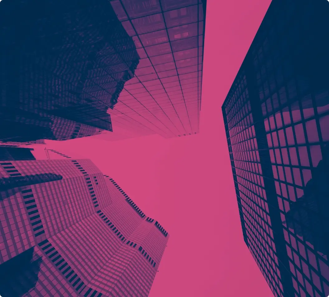 City buildings London2x | Whitehouse Communications Upward view of tall modern skyscrapers converging toward a pink sky, taken from street level.