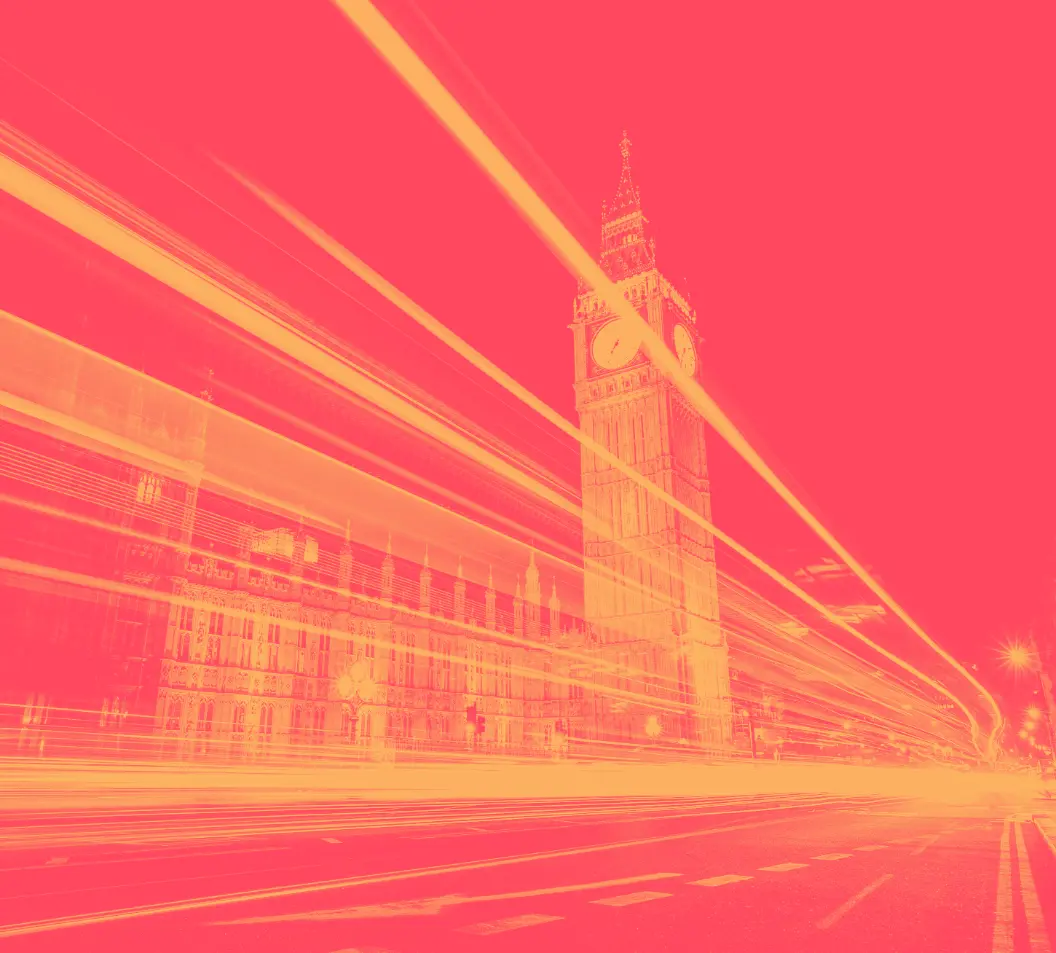 Westminster 22x | Whitehouse Communications Long-exposure night photo of Big Ben and the Houses of Parliament with bright light trails streaking across the scene.